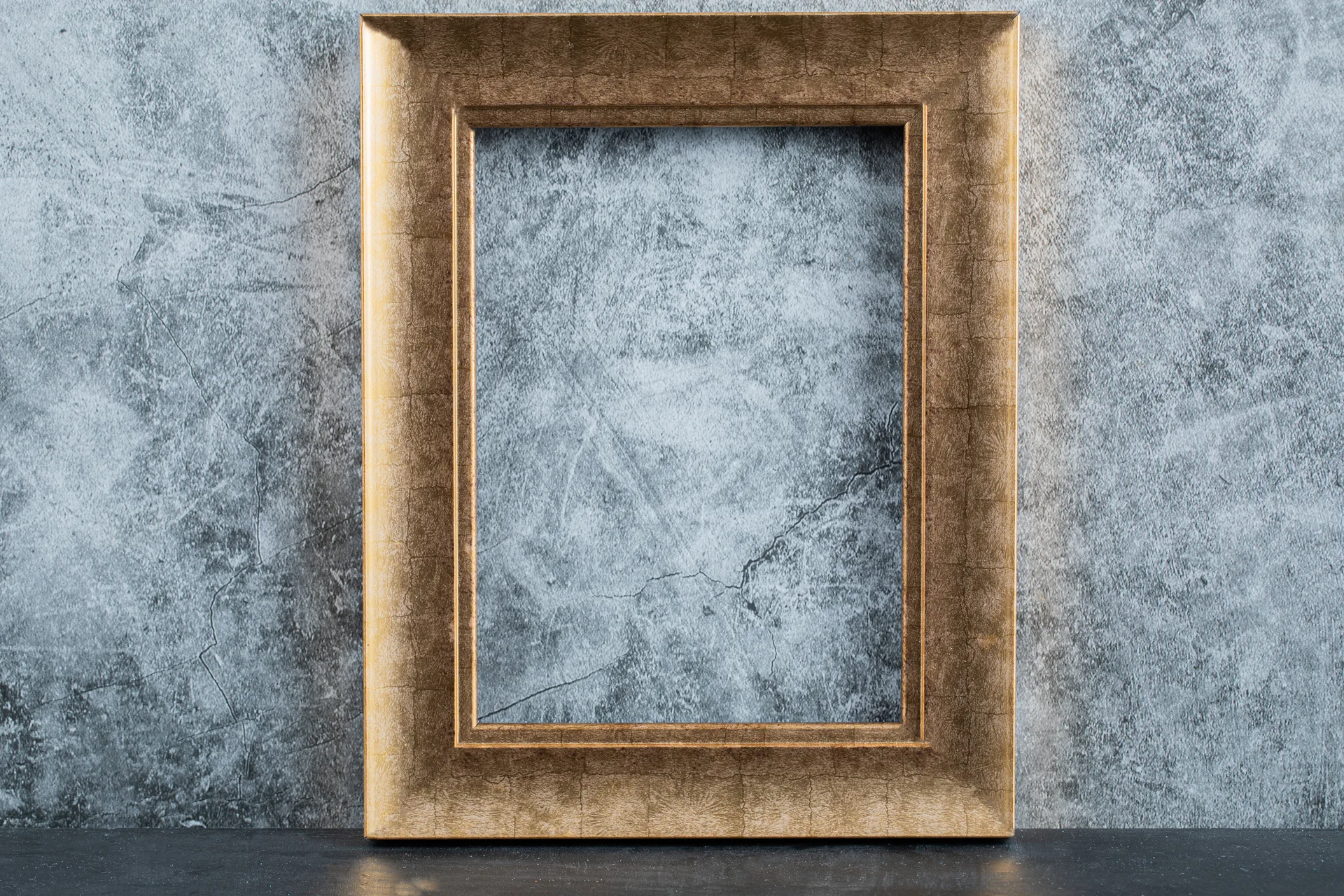 Leerer vergoldeter Bilderrahmen an einer dunklen Museumswand als Sinnbild für entfernte und verbotene Kunst